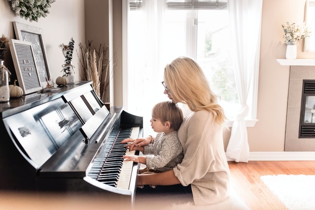 Child learning to play the piano