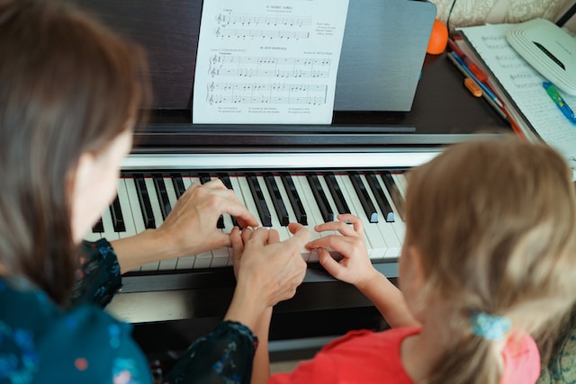 Girl being taught Piano